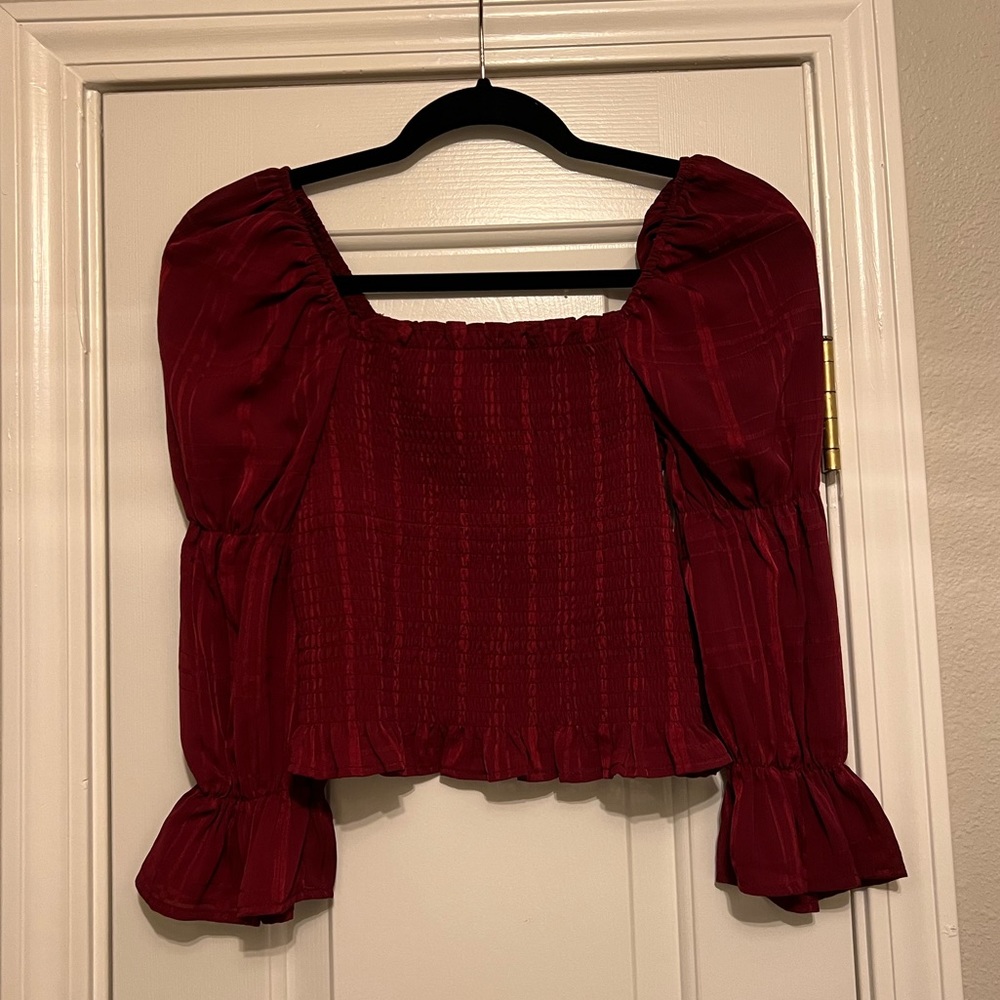 Evolutionary red smocked top